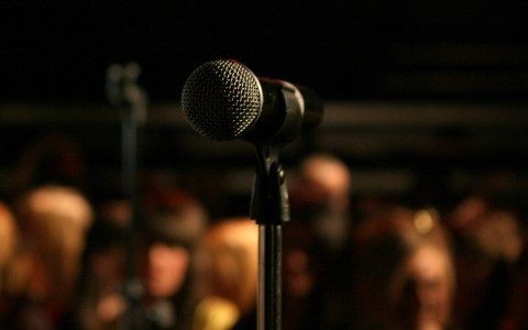 improv mic with audience in background